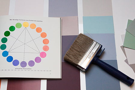 black brush beside unfold book thumbnail