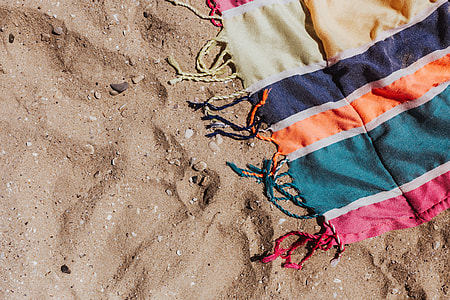Colorful beach towel on the sand thumbnail