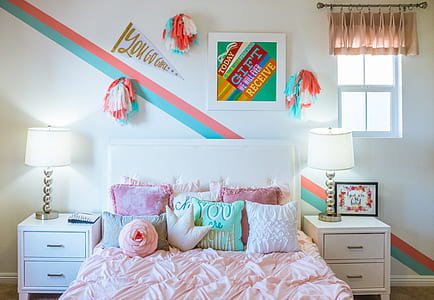 white bed with comforter between white wooden nightstands thumbnail