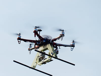 red and white six-axis drone flying thumbnail
