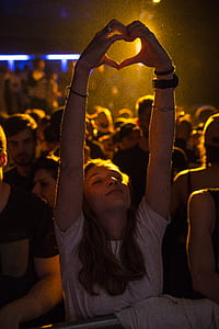 woman forming heart hand sign thumbnail