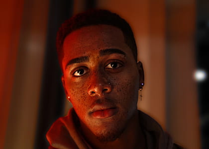 closeup photo of man with cross earring thumbnail