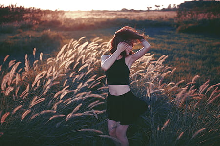 woman in black crop top and mini skirt on field thumbnail