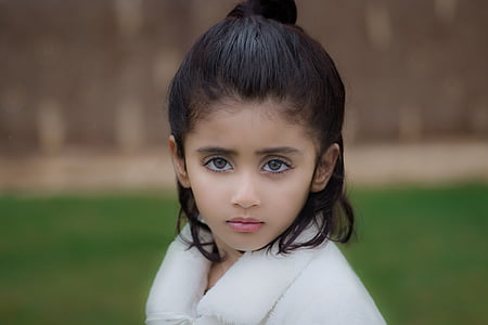 portrait photography of black haired woman in white fur coat thumbnail