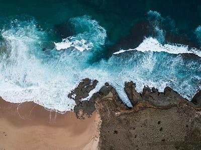 aerial photography of blue sea wave and grey sand thumbnail
