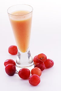 round clear glass cup filled with orange liquid thumbnail