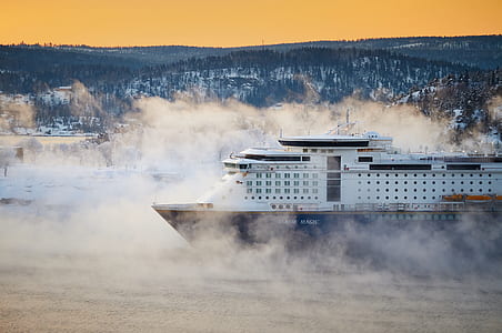 blue and white cruise ship on body of water thumbnail