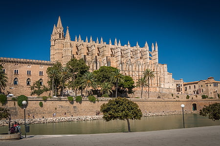 brown concrete building near body of water thumbnail