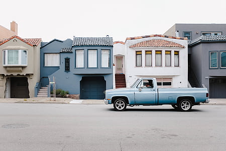 classic gray single cab pickup truck parked near buildings thumbnail
