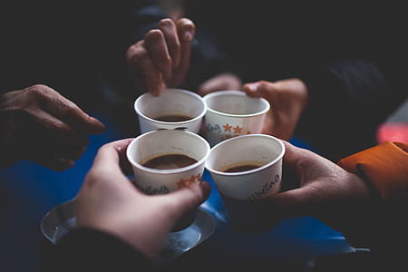 people holding white disposable cups thumbnail