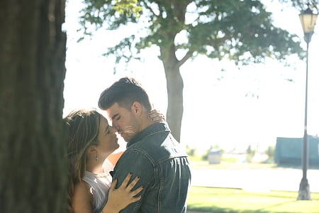 couple about to kiss near post and trees thumbnail