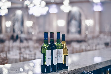 four glass bottles on selective focus photo thumbnail