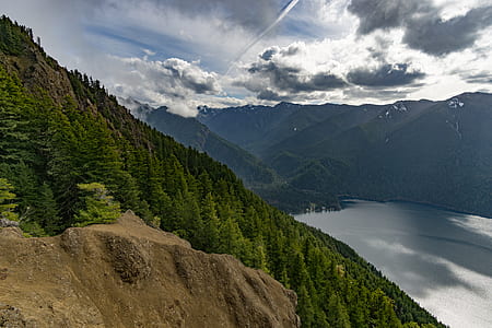 landscape photography of mountain range with trees thumbnail