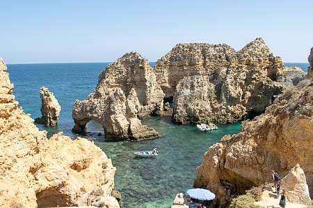 rock formation surrounded by body of water thumbnail