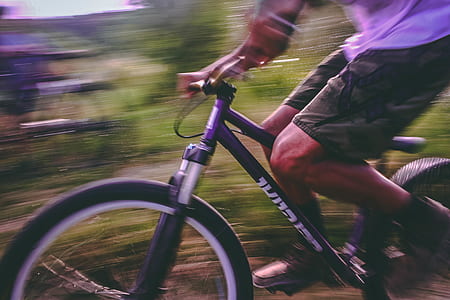 Time Lapse Photo Of Man Riding On Bicycle thumbnail