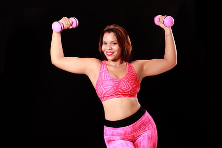 woman holding two pink dumbbells thumbnail