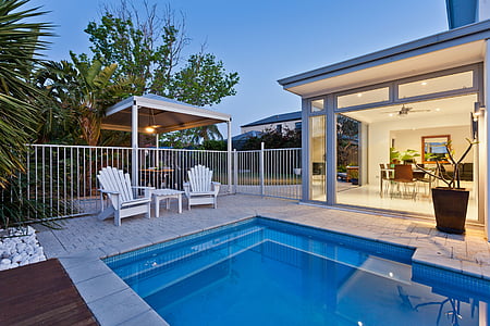 two white wooden armchairs near swimming pool thumbnail