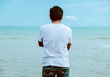 man standing near body of water thumbnail