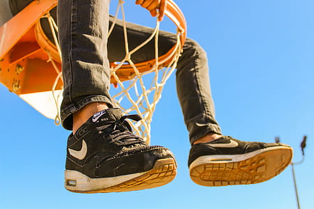 person sits on basketball hoop thumbnail