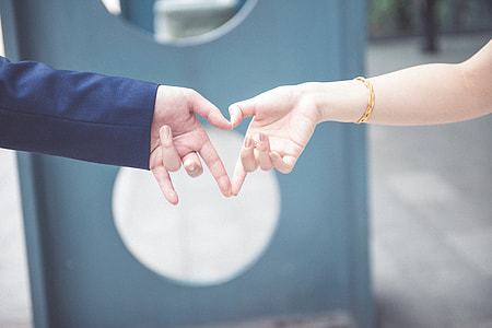 focus photo of two person holding hands thumbnail