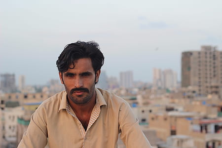 man standing near buildings thumbnail