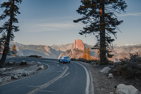 blue car on concrete road thumbnail