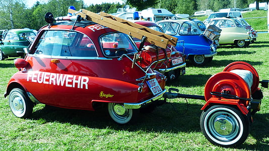 red Feuerwehr vehicle on green grass thumbnail