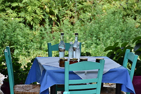 clear glass bottles on wooden table thumbnail