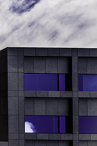 gray building under white clouds thumbnail