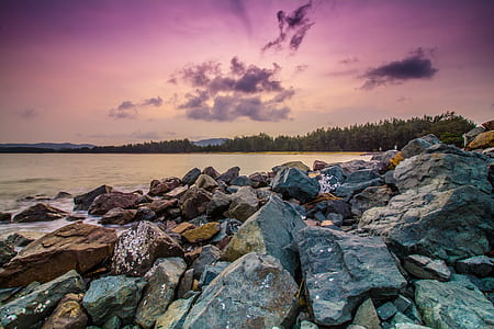 beige and gray stones beside water thumbnail