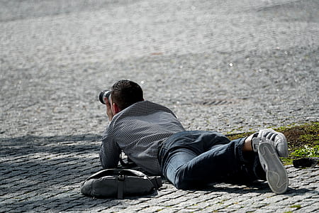 man holding DSLR camera thumbnail