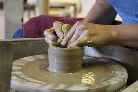 person sitting down molding clay thumbnail
