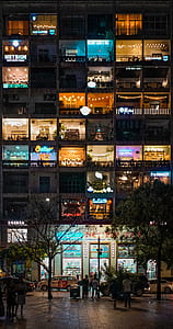 group of people on street in front of lighted building thumbnail