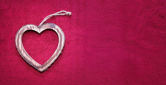 pink heart hanging decor on red textile thumbnail