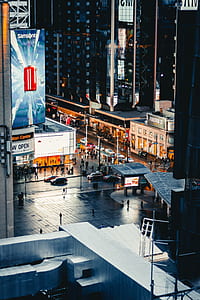 crowd of people walking on street between buildings during night time thumbnail