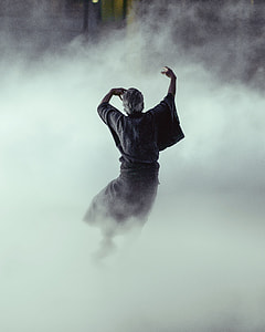 man dancing surrounded by smoke thumbnail