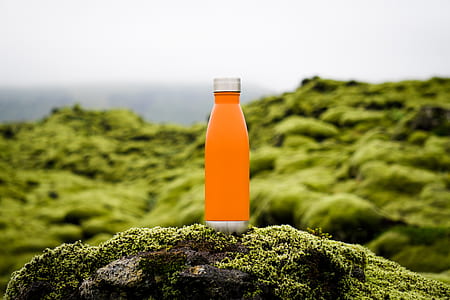 clear glass sports bottle on rock thumbnail