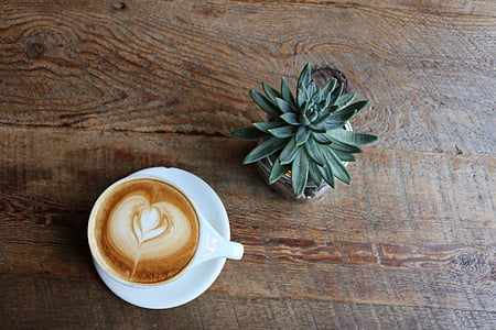 cup of latte on brown wooden table thumbnail