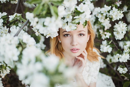 woman surrounded by white flowers photograph thumbnail