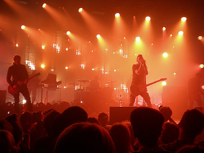 band performing on stage in front of crowd inside venue thumbnail