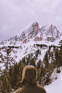 person staring on brown mountain filled with snow thumbnail