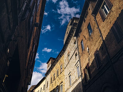 brown houses under white clouds during daytime thumbnail