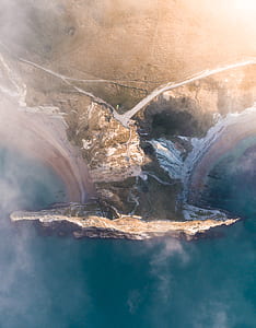 bird's-eye photography of mountains beside body of water thumbnail