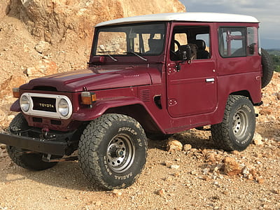 red SUV near rock mountain thumbnail