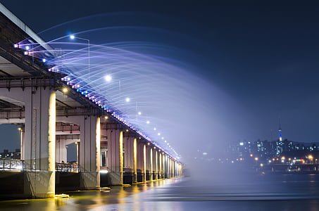 beige concrete bridge under blue sky at night time thumbnail