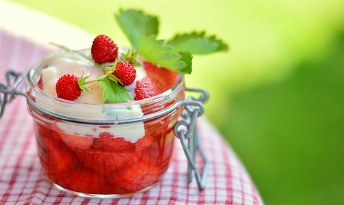 selective focus photography clear glass of strawberries with syrup and whip cream thumbnail