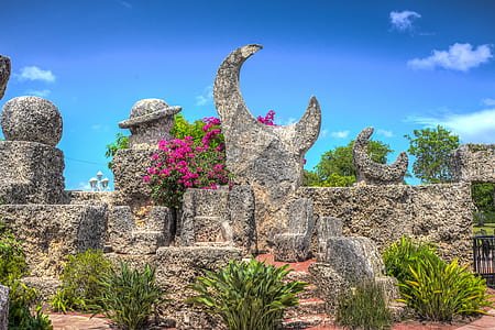 concrete statues beside green plants thumbnail