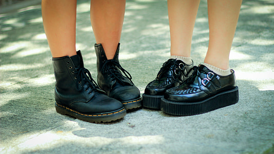 two people wearing black leather shoes thumbnail
