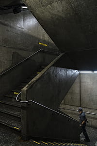 man walking down gray stairs thumbnail