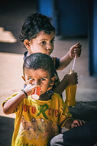 baby boy drinking beside girl during daytime thumbnail